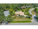 Expansive aerial view of a single-story home with lush landscaping and a well-maintained yard in a suburban neighborhood at 3647 Country Place Blvd, Sarasota, FL 34233