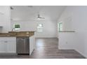 View of open-concept kitchen featuring stainless steel dishwasher and granite countertop bar at 3712 19Th E St, Bradenton, FL 34208