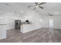 Bright, open-concept living room and kitchen with stainless steel appliances and ceiling fans at 3712 19Th E St, Bradenton, FL 34208