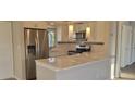 Bright modern kitchen features stainless steel appliances, stone countertops and updated fixtures at 3751 S School Ave # 19, Sarasota, FL 34239