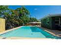 Inviting backyard pool with tranquil blue water, surrounded by lush landscaping and a privacy fence at 4616 22Nd W Ave, Bradenton, FL 34209