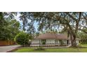 Beautiful home featuring manicured landscaping and a spacious driveway with ample parking at 4916 Hidden Oaks Trl, Sarasota, FL 34232