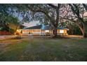 Inviting single-story home boasting manicured lawns and mature, picturesque shade trees at 4916 Hidden Oaks Trl, Sarasota, FL 34232