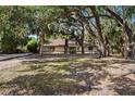 Charming home surrounded by mature trees offering shade and privacy at 4916 Hidden Oaks Trl, Sarasota, FL 34232