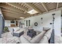 Relaxing outdoor living space with comfortable seating and a built-in grill, perfect for entertaining at 4916 Hidden Oaks Trl, Sarasota, FL 34232