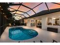 Sparkling private pool with a screened-in enclosure, perfect for relaxing and entertaining at 5023 Brickell Park Cv, Bradenton, FL 34211