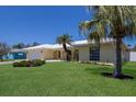Beautifully landscaped front yard featuring a well-maintained lawn and mature palms at 508 70Th St, Holmes Beach, FL 34217