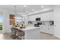 Bright eat-in kitchen with a large island, modern appliances, and stylish pendant lighting at 5632 Summit Pointe Cir # 101, Bradenton, FL 34210