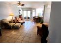 Spacious living room with tile flooring, leading to an open kitchen and a view of the backyard at 6631 63Rd E Ter, Bradenton, FL 34203
