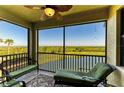 Relaxing screened lanai with comfortable seating and scenic water and green views at 7005 River Hammock Dr # 402, Bradenton, FL 34212