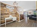 Foyer area features rustic wood accents, a staircase, and views into the living space at 7107 58Th E Ter, Palmetto, FL 34221