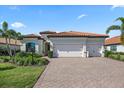 Lovely home with a three-car garage, clay tile roof and lush landscaping at 7113 Whittlebury Trl, Bradenton, FL 34202