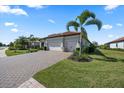 Three-car garage and well manicured front lawn with beautiful landscaping at 7113 Whittlebury Trl, Bradenton, FL 34202
