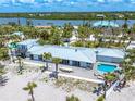 Spacious beachfront home with a pool, deck, and outdoor dining area with water views at 722 N Manasota Key Rd, Englewood, FL 34223