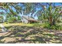 Expansive property featuring a two-story home, large yard, and mature trees at 7407 91St E St, Palmetto, FL 34221