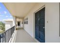 Hallway view showcasing unit 408's entrance with a dark front door, contrasted against the light hallway walls and flooring at 7461 W Country Club Dr N # 408, Sarasota, FL 34243