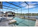 Enjoy this refreshing screened-in pool and lanai with scenic views of the peaceful lake at 7859 Yale Harbor Dr, Wesley Chapel, FL 33545
