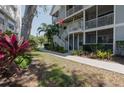 Charming condo building with white railings, lush landscaping, and a well-maintained lawn at 850 S Tamiami Trl # 836, Sarasota, FL 34236