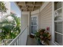 Inviting porch with potted plants and a view of the surrounding greenery at 850 S Tamiami Trl # 836, Sarasota, FL 34236