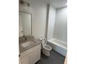 Modern bathroom featuring subway tile, a granite-topped vanity, and modern fixtures at 8810 1/2 N Mulberry St, Tampa, FL 33604