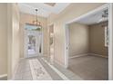 Inviting foyer with tile flooring, a stylish light fixture, and a view into adjacent rooms, enhancing the home's openness at 1363 New Forest Ln, Osprey, FL 34229