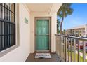 Condo entrance with a welcome mat, window, and balcony railing at 175 Kings Hwy # 428 B8, Punta Gorda, FL 33983