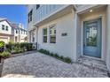 Inviting entrance showcasing a well-maintained paved patio and a stylish blue front door at 2340 Lindstrom St, Sarasota, FL 34237
