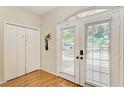 Bright entryway features double doors with blinds, a closet, and wood-look floors at 2611 221St E St, Bradenton, FL 34211
