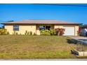Charming single-story home featuring a neatly landscaped front yard and an attached one-car garage at 2707 Vinson Ave, Sarasota, FL 34232
