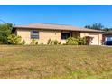 Charming single-story home featuring a neatly landscaped front yard and an attached one-car garage at 2707 Vinson Ave, Sarasota, FL 34232