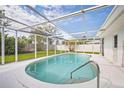 The covered pool area features a clean design with a bright white deck and a clear view of the blue sky at 3130 Key Way, Sarasota, FL 34239