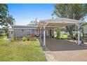 Well-maintained single-story home with a covered carport, mature trees, and manicured lawn at 3333 26Th E Ave # 1004, Bradenton, FL 34208