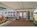 Inviting porch area with comfortable seating, double doors, and views of manicured landscaping at 3333 26Th E Ave # 1004, Bradenton, FL 34208
