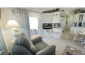 Bright living room with a view of the patio and adjacent kitchen, creating a seamless indoor-outdoor flow at 3333 26Th E Ave # 1257, Bradenton, FL 34208
