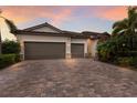 A charming, single-story home featuring a two-car garage and a beautiful brick driveway at 3512 Scrub Creek Run, Lakewood Ranch, FL 34211