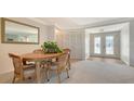 Inviting dining area with carpet flooring, and bright lighting from the front double-door entry at 3522 Ferndell, Sarasota, FL 34235