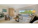 Bright living room featuring neutral colors, large windows, and access to the outdoor patio at 3522 Ferndell, Sarasota, FL 34235