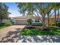 Inviting single-story home featuring a brick paver driveway and a two-car garage at 358 River Enclave Ct, Bradenton, FL 34212