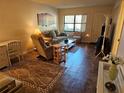 Comfortable living room featuring neutral tones, a large window, and tiled floor at 425 30Th W Ave # C104, Bradenton, FL 34205