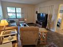 Inviting living room featuring a comfortable seating arrangement and view to the bedroom at 425 30Th W Ave # C104, Bradenton, FL 34205