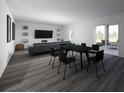 Open concept living and dining area with modern decor and sliding glass doors to the backyard at 4610 Hawthorn Avenue, Parrish, FL 34219