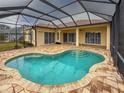 Relaxing screened-in pool area featuring brick pavers and multiple sliding glass doors for seamless indoor-outdoor living at 4613 Sweetmeadow Cir, Sarasota, FL 34238