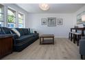 Comfortable living room with stylish sofa, decorative lighting, and wood-look floors at 466 Sunnyside Dr, Venice, FL 34293