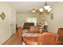 Cozy dining area with a wooden table and chairs, laminate flooring, and a chandelier at 4754 Sabal Key Dr, Bradenton, FL 34203