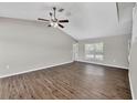 Spacious bedroom with a ceiling fan and large window; vinyl plank flooring throughout at 5642 29Th Street E Cir, Bradenton, FL 34203