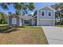 Inviting two-story home with a manicured lawn and a classic gray and white color palette at 5642 29Th Street E Cir, Bradenton, FL 34203
