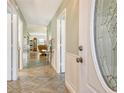 Welcoming foyer with tile flooring, wainscoting, and a decorative glass front door at 6007 Vivienda Dr # 29, Bradenton, FL 34207
