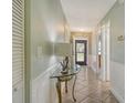 Bright hallway with tile floors and elegant wainscoting leading to various rooms in the home at 6007 Vivienda Dr # 29, Bradenton, FL 34207