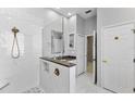 Bright bathroom featuring a glass shower, modern fixtures, and white marble patterned tile at 6532 Copper Ridge Trl, Bradenton, FL 34201
