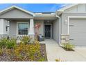 Inviting front porch with a cozy seating area and tasteful landscaping at 6708 162Nd E Pl, Parrish, FL 34219
